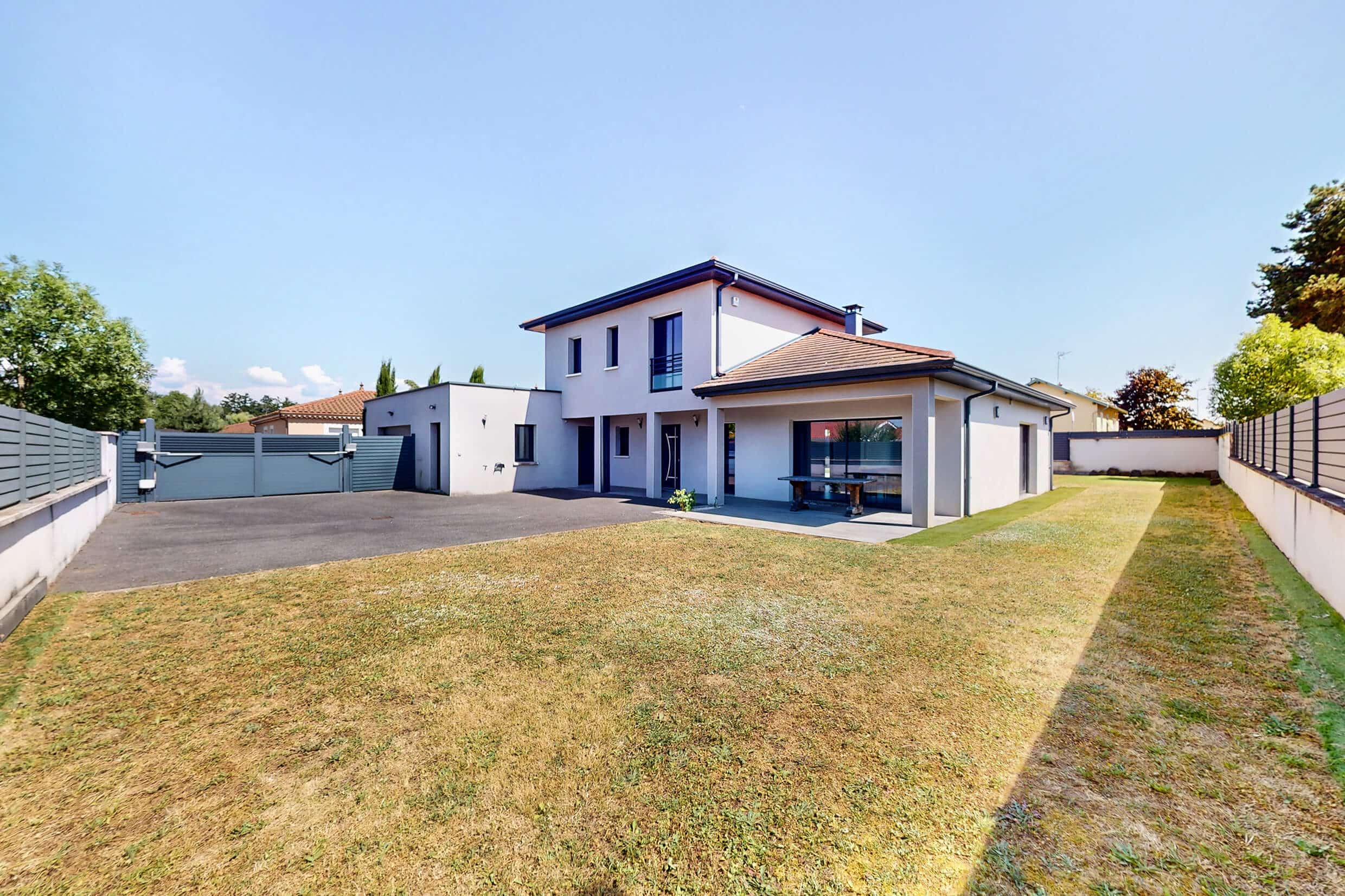 Façade moderne d’une maison contemporaine à Saint-Romain-de-Jalionas avec grand terrain et espace stationnement